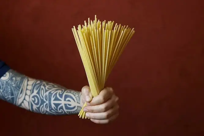 raw-pasta-hands-bucatini-pasta