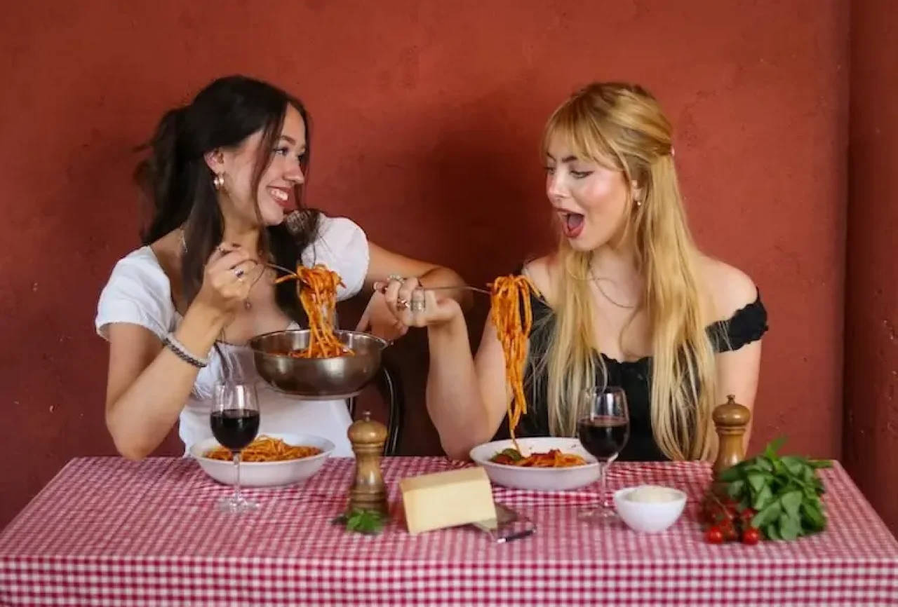 Young people enjoying eating pasta 3 mobile